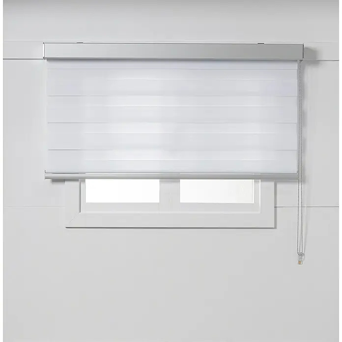 Estor noche y día Luxury - An x Al: 150 x 250 cm, Blanco - Elegante persiana blanca frente a una ventana, que deja entrar luz suavemente y ofrece privacidad.