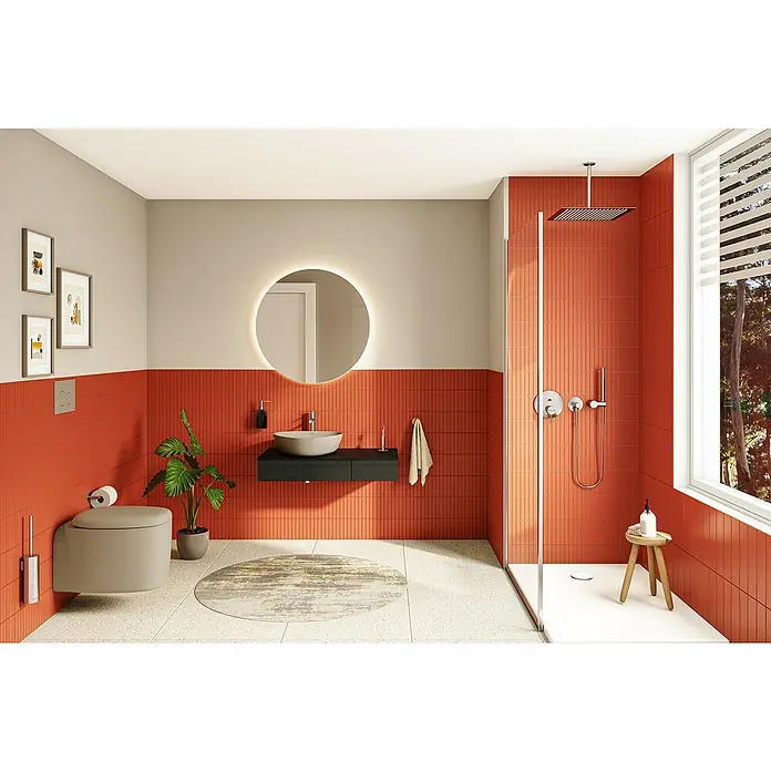 VitrA Plural Wand-WC - Spülrandlos, Mit schmutzabweisender Glasur, Spülform: Tief, WC Abgang: Waagerecht, Taupe - Modernes Badezimmer mit orangefarbenen Fliesen, einem runden Spiegel und einem stilvollen Waschtisch, der eine elegante Raumatmosphäre schafft.
