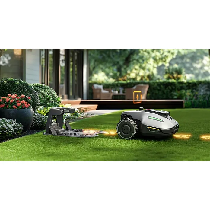 Mammotion Mähroboter Yuka Mini 800800 m², Schnittbreite: 190 mm, Satellitengestützte Navigation, RTK - Ein Mammotion-Rasenmähroboter lädt sich an seiner Ladestation auf, bereit für die nächste Rasenmährunde.