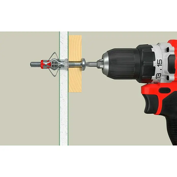 Fischer Hohlraumdübel DuoHM 6x55 S TX - Ø x L: 12 x 55 mm, Metall, 4 Stk., M 6 - Eine Spreizdübel wird mit einem roten Bohrschrauber in eine Wand geschraubt. Die Dübel dient zur Befestigung von Gegenständen.