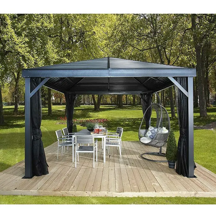 Sojag Standard-Pavillon Premium South Beach 1212 - Basaltgrau, Aluminium, B x T: 364,3 x 364,3 cm - Dunkelgraues Metallpavillon mit schwarzen Netvorhängen, bietet Ess- und Entspannungsbereich im Freien auf einer Holzterrasse.