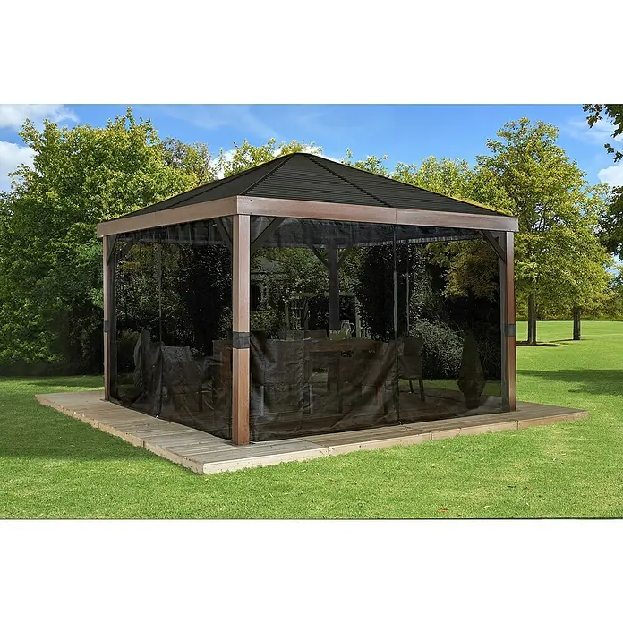 Sojag Standard-Pavillon Premium South Beach 1212 - B x T: 34,3 x 364,3 cm, Braun, Aluminium - Brauner Holzpavillon mit dunklem Wellblechdach und schwarzen Netzvorhängen auf Holzterrasse in sonnigem Garten mit Rasen und Bäumen.