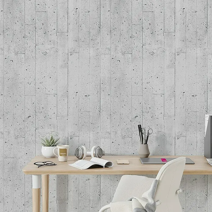 Lámina decorativa autoadhesiva vinílico Premium - 90 x 280 cm, Encofrado, Gris - Primer plano de un escritorio con un moderno fondo de pared de hormigón, perfecto para un espacio de trabajo minimalista.