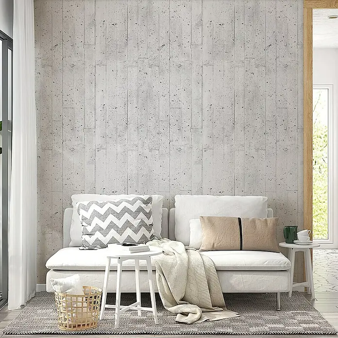 Lámina decorativa autoadhesiva vinílico Premium - 90 x 280 cm, Encofrado, Gris - Sofá luminoso con cojines y manta en una sala de estar amueblada modernamente con una pequeña mesa. El diseño interior se ve acogedor.