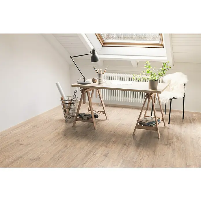 Egger Laminat NatureSense - Woodwork Eiche, Landhausdiele, 1.292 x 193 x 7 mm - Ein Arbeitszimmer mit einem hellen Holzboden, einem Schreibtisch mit einer Lampe und einer Pflanze, sowie einem Fenster an der Decke.