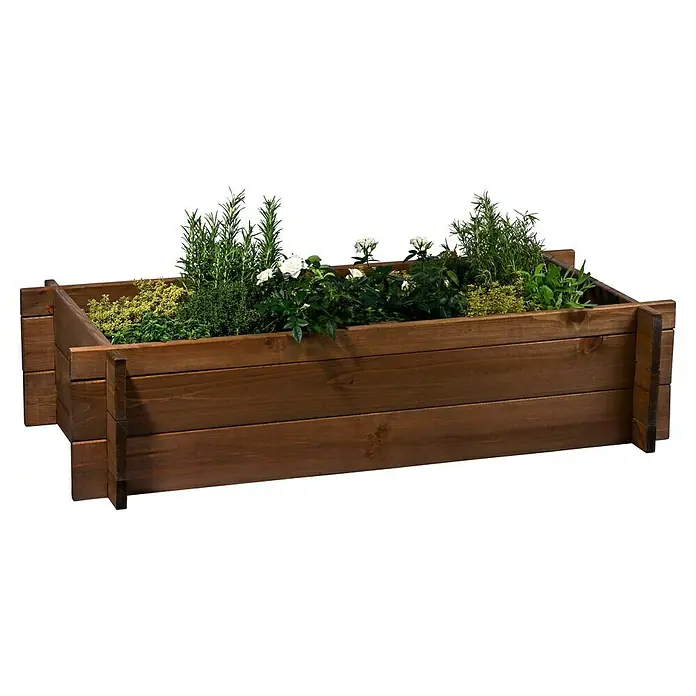 Dobar Hochbeet M - 117 x 58,5 x 27,5 cm, Holz, Teak - Brauner Holzpflanzkasten gefüllt mit grünen Kräutern und weißen Blumen.