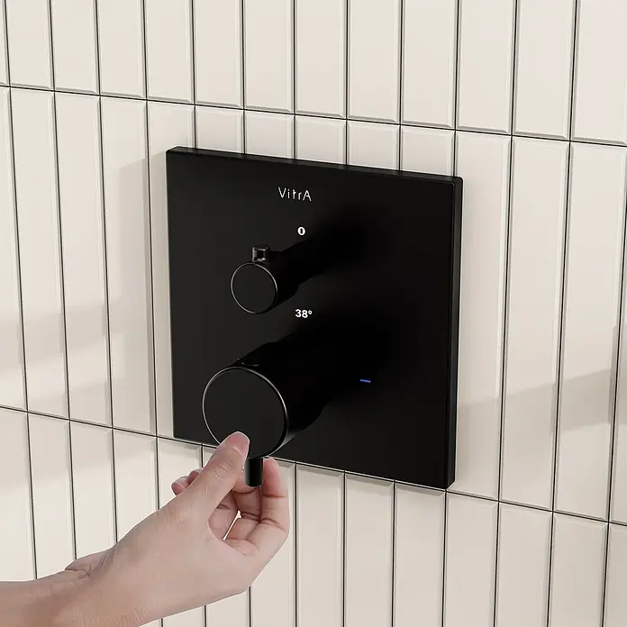VitrA Flow Square UP-Badewannenarmatur - Ausladung Armatur: 89 mm, Schwarz, Matt - Mattschwarzes VitrA Duschbedienfeld mit zwei Drehknöpfen. Eine Hand stellt den unteren Knopf auf 38° ein.