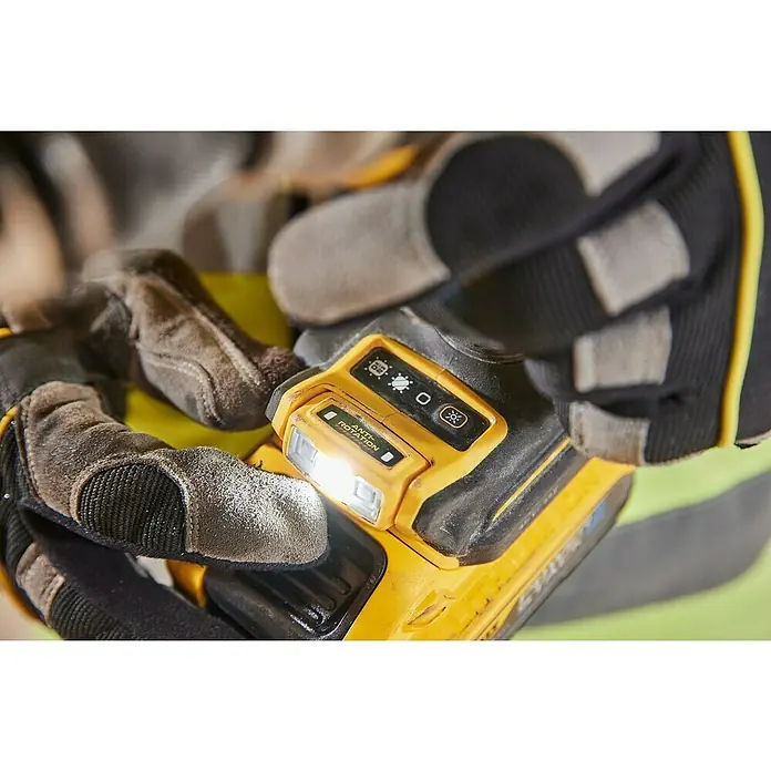 DeWalt XR 18V Taladro atornillador percutor de batería DCD1007W -  - Primer plano de una luz de trabajo DeWalt sostenida en la mano con un guante, que brilla intensamente, ideal para obras y talleres.