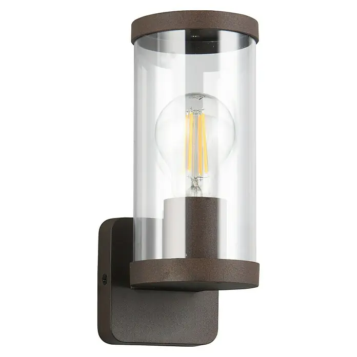 Trio Lighting Aplique exterior Bonito - 28 W, 9 x 9 x 23 cm, Marrón, IP44 - Primer plano de una lámpara de pared con cristal cilíndrico transparente y acabado rústico, que emite una luz cálida y acogedora.