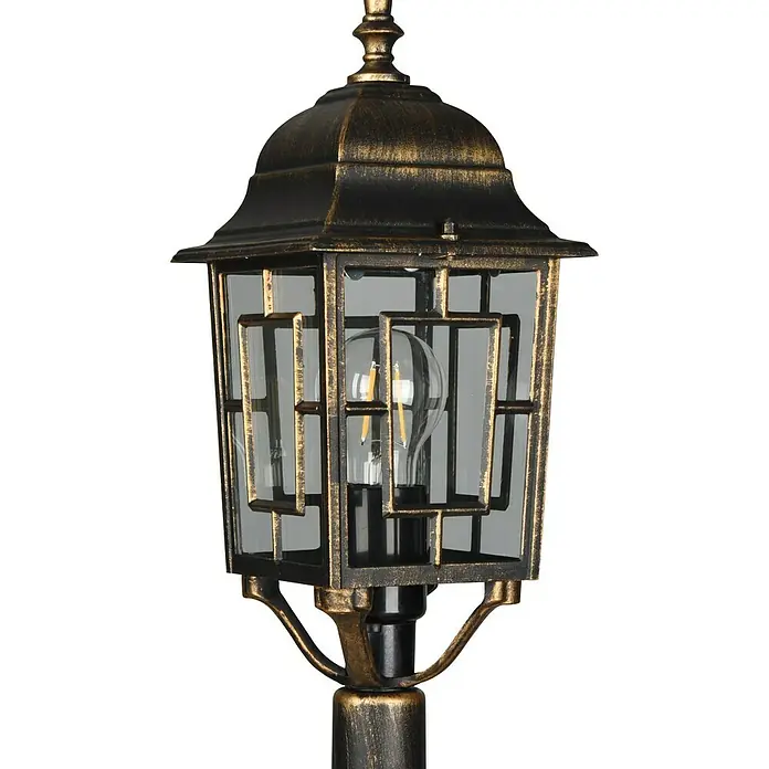 Trio Lighting Lámpara de pie para exterior Volturno - 60 W, Color del marco: Bronce, 17 x 15 x 100 cm, Sin bombillas - Una toma detallada de una farola clásica con un acabado antiguo y un brillo cálido y acogedor.