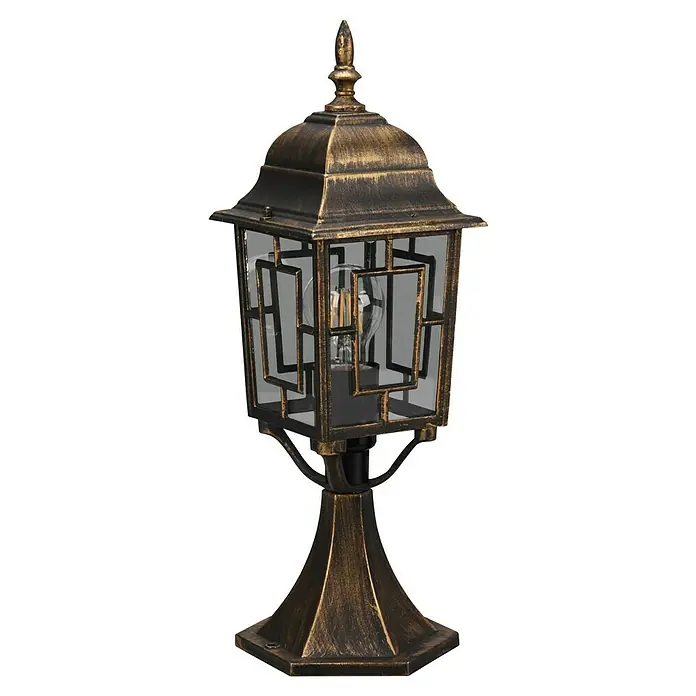 Trio Lighting Sobremuro exterior Volturno - Color del marco: Bronce, 17 x 15 x 47 cm, Sin bombillas - Primer plano de una lámpara de exterior color bronce con un diseño decorativo y una bombilla en su interior. La lámpara tiene forma elegante y aspecto antiguo.