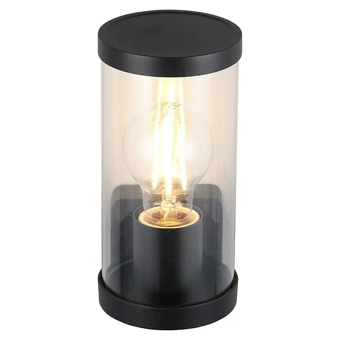 Trio Lighting Aplique exterior Bonito - 28 W, 9 x 9 x 23 cm, Negro, IP44 - Primer plano de una lámpara moderna para exteriores con vidrio transparente y base negra, que emite una luz cálida.