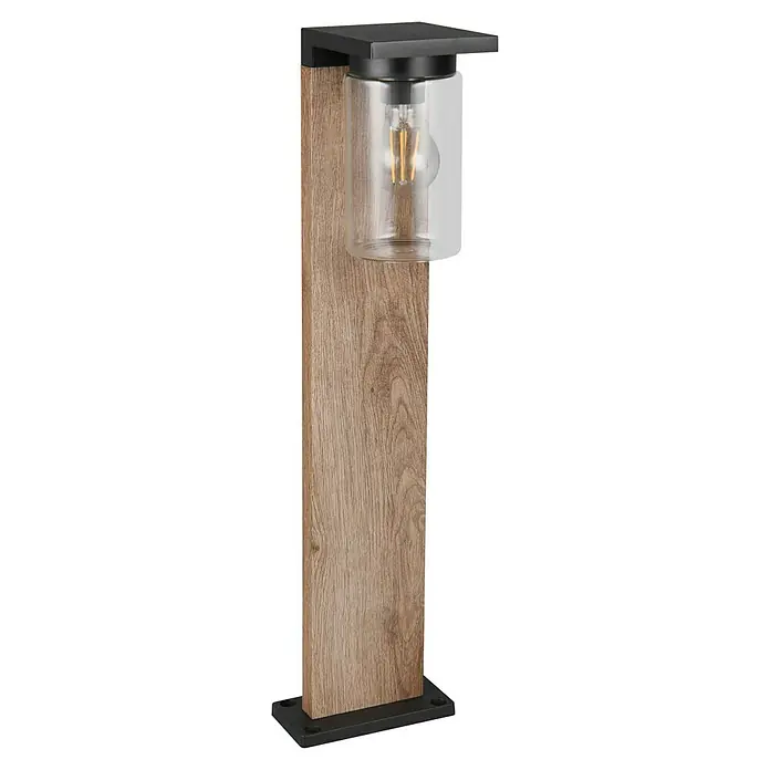Trio Lighting Sobremuro exterior Ardila - 40 W, Color del marco: Marrón - Primer plano de una elegante lámpara de exterior con efecto madera, marco de metal negro y cilindro de vidrio transparente, mostrando una bombilla decorativa.