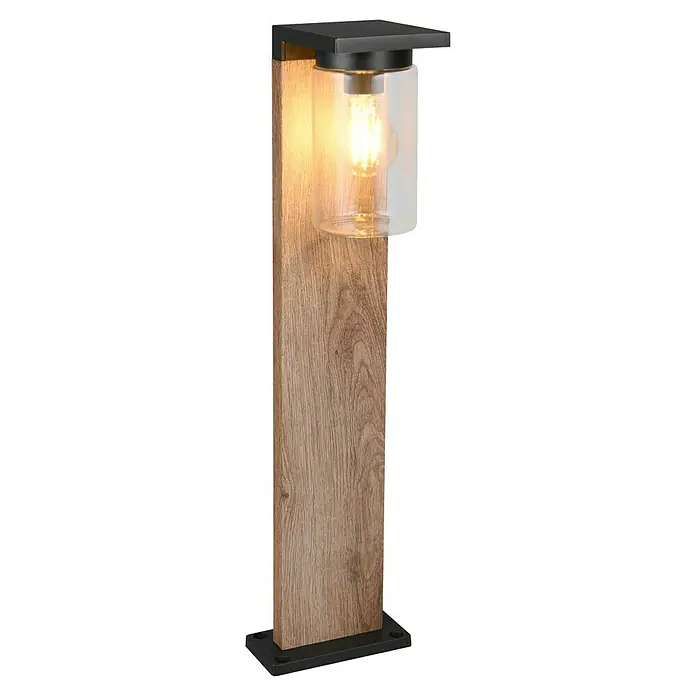 Trio Lighting Sobremuro exterior Ardila - 40 W, Color del marco: Marrón - Primer plano de una elegante lámpara de jardín con base de madera, cilindro de vidrio y bombilla de luz cálida para iluminación exterior ambiental.
