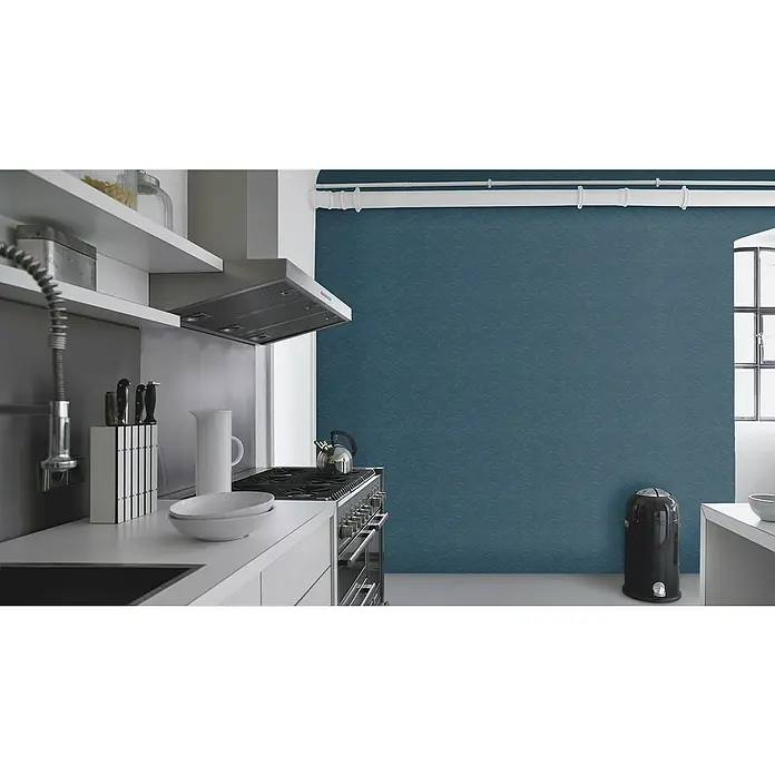 Rasch Selection Vliestapete Vinyl Rainbow - Dunkelblau, Grafisch, 10,05 x 0,53 m - Helle Küche mit Dunstabzugshaube aus Edelstahl über einem Herd, Geschirr auf der Arbeitsfläche und einem schwarzen Mülleimer.