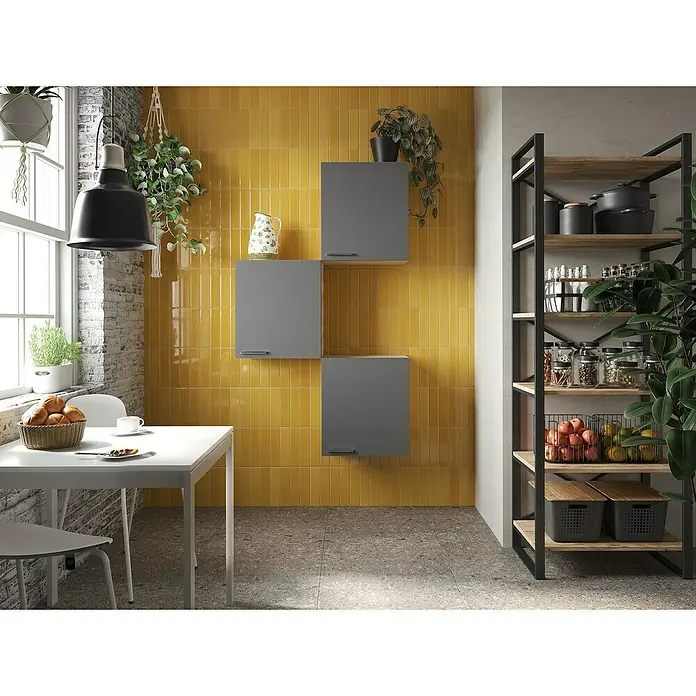Respekta Merle Hängeschrank - B x T x H: 100 x 34,6 x 168,3 cm, Grau, 3 Stk. - Küchenszene mit gelben Wandfliesen und grauen Schränken. Ein Esstisch und ein Regal mit Küchenutensilien ergänzen das Design für mehr Stauraum.