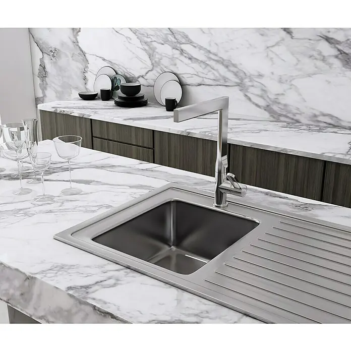 IO Dior Grifo de cocina - Cromo, Brillante - Primer plano de un fregadero moderno de acero inoxidable con escurridor y un elegante grifo, integrado en una encimera de mármol.