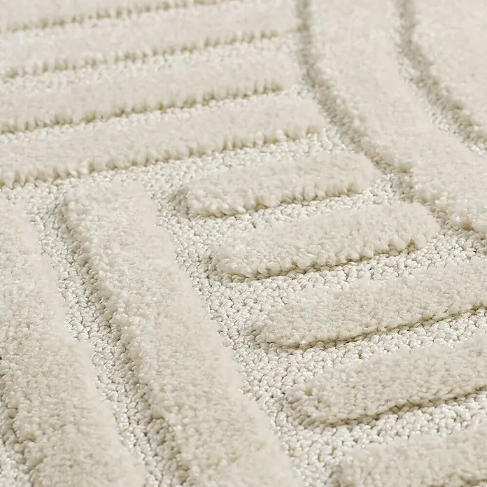 Kurzflorteppich Art - Creme, Durchmesser: 80 cm, 100 % Polypropylen - Detailansicht eines beigen Teppichs mit geometrischen Mustern, der eine weiche und strukturierte Oberfläche zeigt.