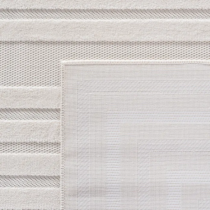 Kurzflorteppich Doha 1653 - Creme, 370 x 280 cm, 100 % Polypropylen - Detailaufnahme eines hellen Teppichs mit Streifenmuster und feiner Textur, der eine elegante und moderne Note verleiht.