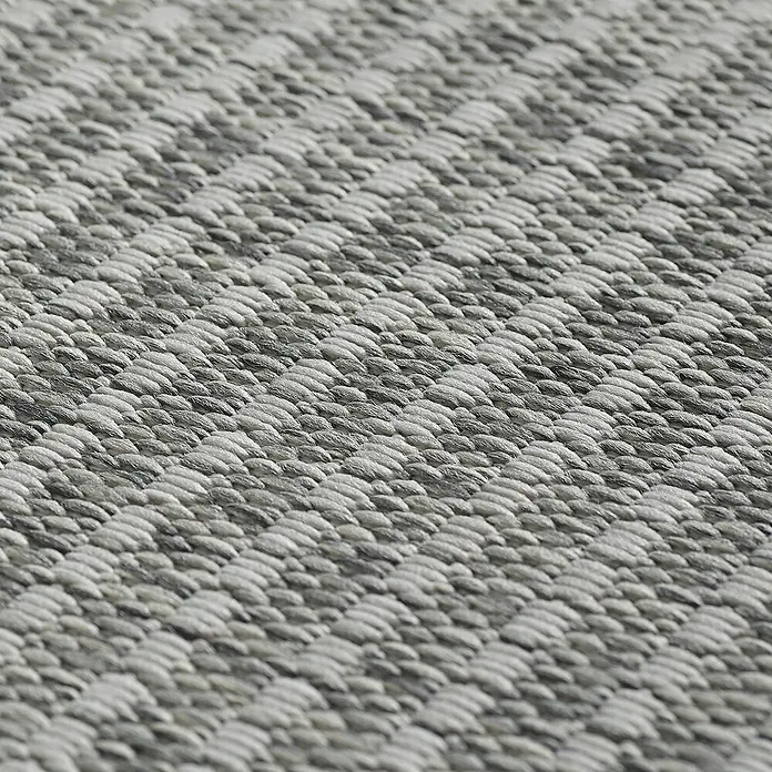 Outdoor-Teppich Giza 1410 - Grau, 340 x 240 cm, 100 % Polypropylen - Nahaufnahme eines Teppichs mit einem strukturierten, zweifarbigen Webmuster in Grau- und Weißtönen, das für eine textile Oberfläche sorgt.