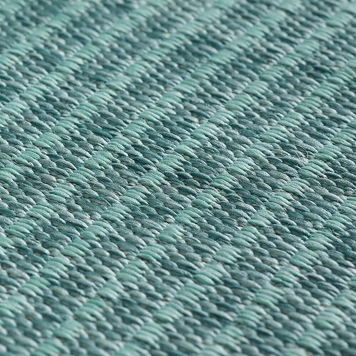 Outdoor-Teppich Giza 1410 - Blau, 200 x 140 cm, 100 % Polypropylen - Nahaufnahme eines türkisfarbenen, gewebten Teppichs, der eine interessante Textur und ein feines Muster aufweist. Ideal als Bodenbelag.