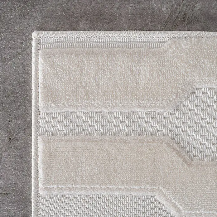 Kurzflorteppich Doha 1654 - Creme, 340 x 240 cm, 100 % Polypropylen - Nahaufnahme eines beigen Teppichs mit geometrischem Muster, der eine weiche Textur und hochwertige Verarbeitung zeigt.