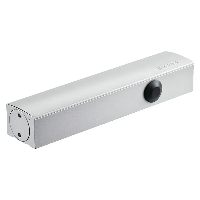 GEZE Türschließer TS 5000 Ecline - L x B x H: 287 x 47 x 60 mm, Max. Türbreite: 1.250 mm, Passend für: Feuerschutztür, für Rauchschutztür, Silber - Ein silberfarbener GEZE Türschließer mit einem runden, schwarzen Knopf an der Seite. Das Gerät ist rechteckig und hat eine runde Abdeckung.
