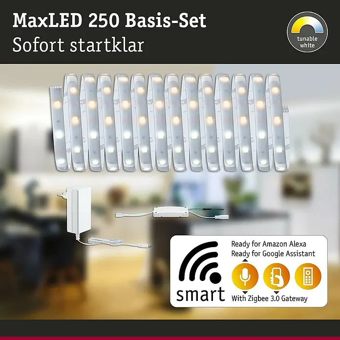 Paulmann MaxLED 250 Smart-LED-Band Basisset beschichtet Zigbee - 500 cm, Warmweiß, 21 W, 1.250 lm, 230 V - 240 V - MaxLED 250 Basis-Set: dimmbarer Weiß-LED-Streifen, Netzteil und Smart-Controller, abgebildet vor einem verschwommenen Raumhintergrund.