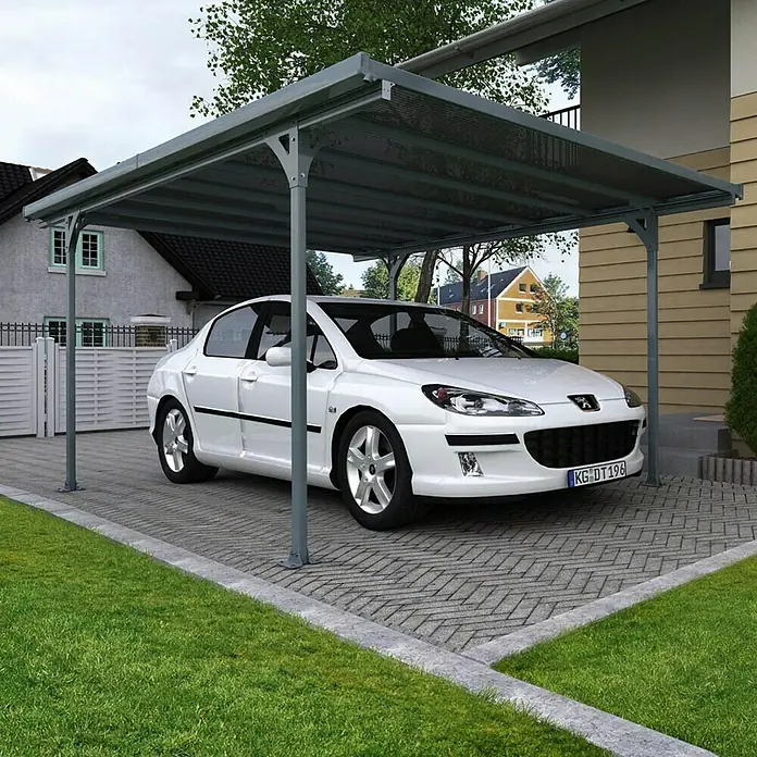 Palram – Canopia Carport Verona 5000 - Medidas ext. (An x Pr): 5,04 x 2,99 m, Aluminio, Carport adecuado para: Turismos - Un coche blanco está aparcado debajo de una cochera gris, ofreciendo protección contra los elementos. La cochera se encuentra sobre una superficie pavimentada.
