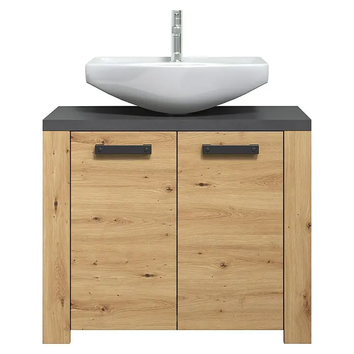 Trendteam Follow Waschtischunterschrank - B x T x H: 79 x 35 x 67 cm, Artisan Eiche, Matt - Badezimmerunterschrank in Holzoptik mit dunkelgrauer Platte, weißem Becken und Chromarmatur, mit zwei Schranktüren und schwarzen Griffen.