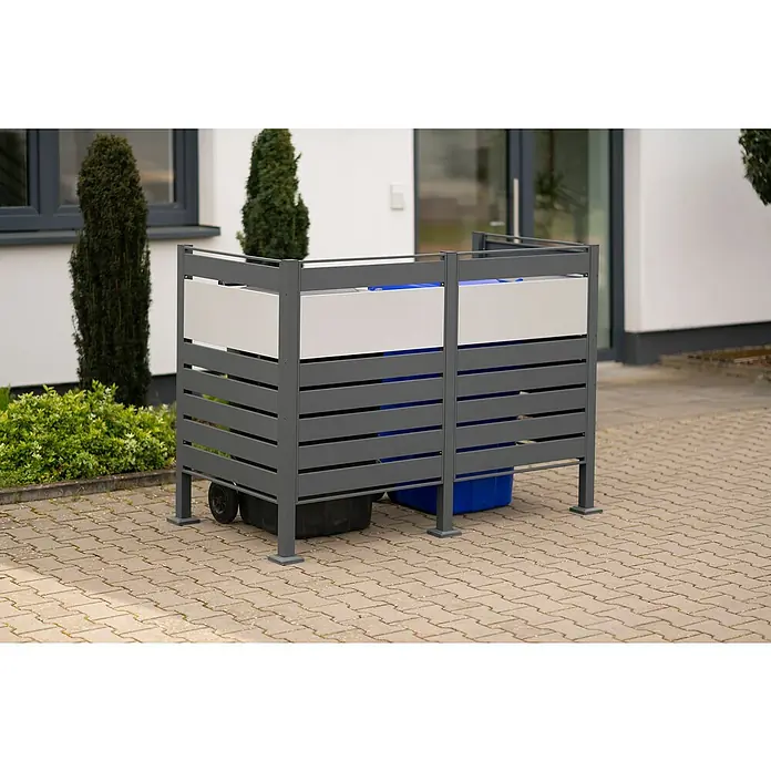 Westmann Mülltonnenbox Verkleidung Planum - 90 x 170 x 120 cm, Anthrazit/Grau - Eine graue Mülltonnenbox mit weißen Akzenten, die zwei Mülltonnen auf einem gepflasterten Bereich im Freien verbirgt.