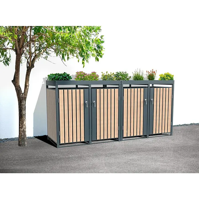 Westmann Mülltonnenbox Planta - Stahl, Anthrazit/Braun, Geeignet für Anzahl Mülltonnen: 4 Stk. - Diese Aufnahme zeigt eine Abfallbox mit Pflanzkastenaufsatz, der mit Pflanzen dekoriert ist. Die Box besteht aus grauem Metall und Holzlatten.