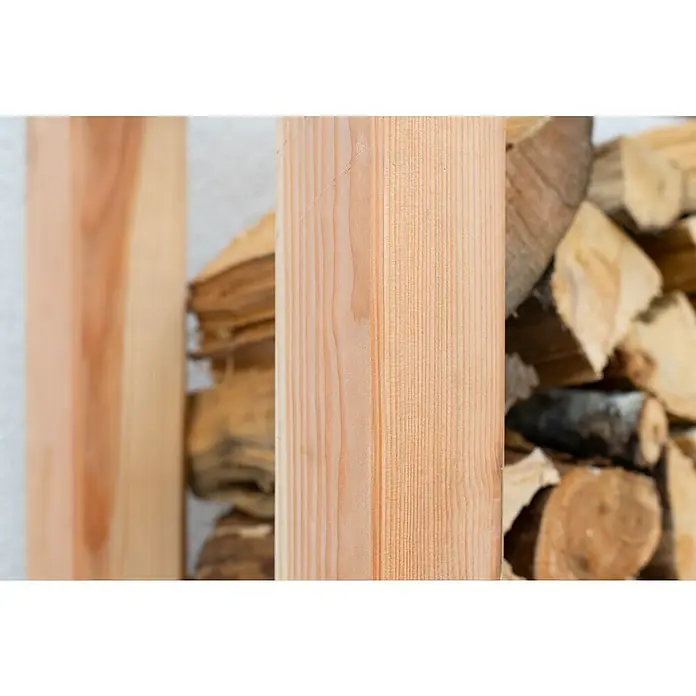 Westmann Kaminholzregal Michel - 138 x 40 x 180 cm, Holz, Natur - Detailaufnahme eines hellen Holzpfostens, der die feine Maserung und Textur hervorhebt, neben einem Stapel Brennholz.