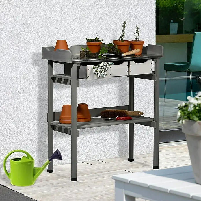 Dobar Pflanztisch - 78 x 38 x 88 cm, Holz, Grau - Ein grauer Gartentisch mit Schubladen, bepflanzten Töpfen und einer grünen Gießkanne. Praktische und stilvolle Ergänzung für jeden Garten.