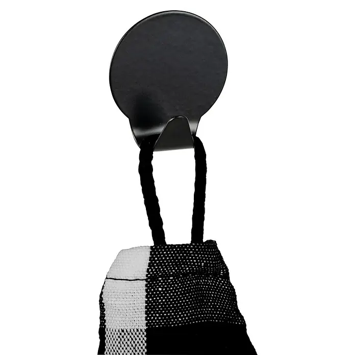Wenko Klebehaken - L x H: 2 x 3,7 cm, 2 Stk. - Aufnahme eines runden, schwarzen Wandhakens mit einem schwarz-weiß gestreiften Tuch, das darauf hängt. Der Haken ist für eine einfache Anbringung konzipiert.
