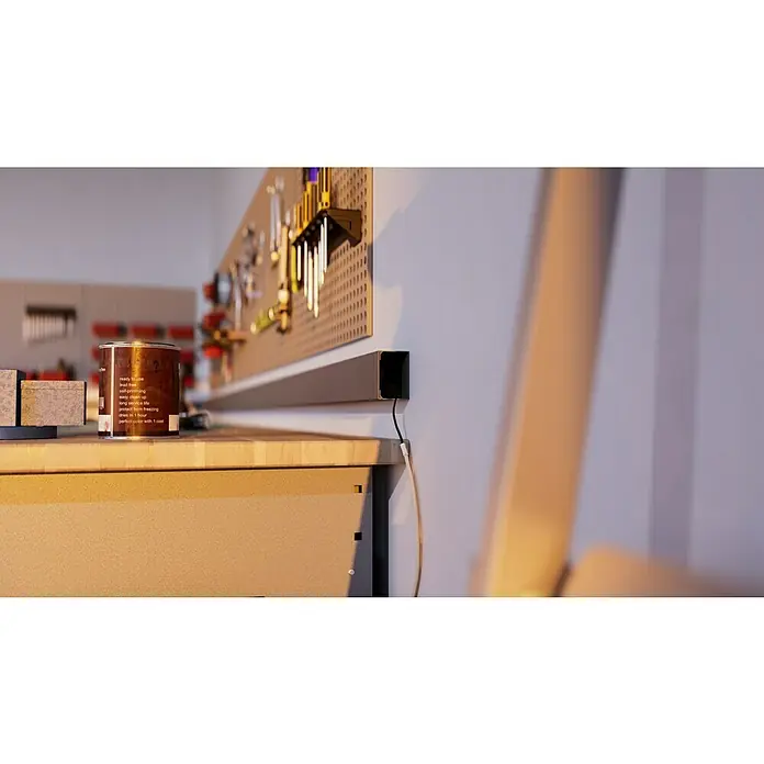 Kabelkanal - L x B x H: 2 m x 60 mm x 40 mm, Grau - Werkstatt-Szene mit Fokus auf einer Dose Holzbeize auf einer Werkbank, einem Werkzeugbrett und einer Steckdosenleiste an der Wand.