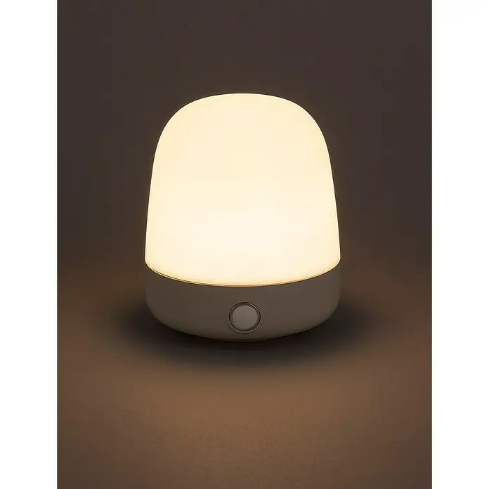 Starlux Akku-Tischleuchte Mini - L x B x H: 10 x 10 x 12 cm, Beige, RGBW, 0,3 W, IP44 - Nahaufnahme einer Nachttischlampe mit einem sanften, warmen Licht, ideal für eine beruhigende Atmosphäre im Schlafzimmer.