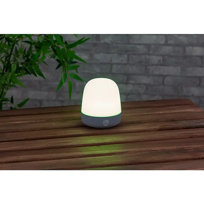 Starlux Akku-Tischleuchte Mini - L x B x H: 10 x 10 x 12 cm, Light Grey, RGBW, 0,3 W, IP44 - Nahaufnahme einer stilvollen, modernen Tischleuchte, die ein warmes, einladendes Licht ausstrahlt, perfekt für jede Einrichtung.