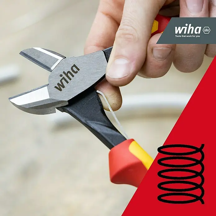 Wiha Seitenschneider Industrial Electric - Länge: 27 cm - Wiha Seitenschneider, silber mit schwarzen, roten und gelben Griffen, durchtrennt ein weißes Kabel in einer Hand.