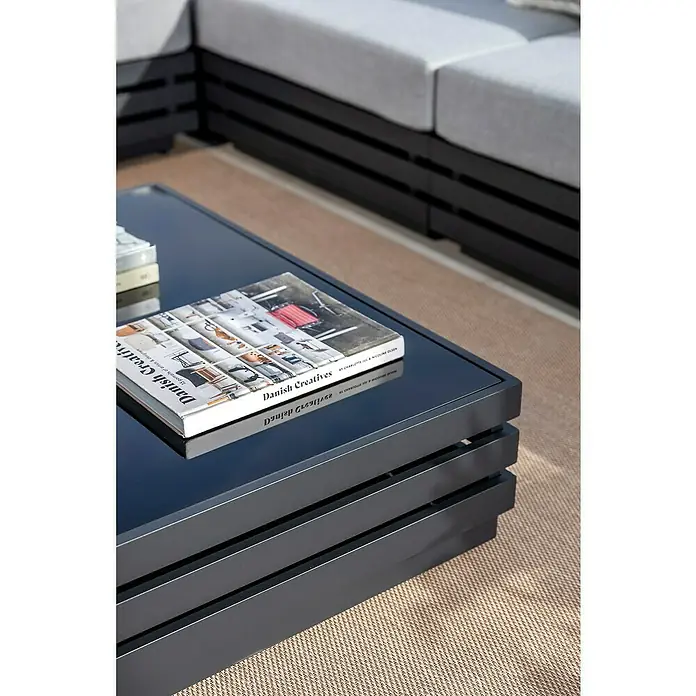 Sunfun Loungemöbel-Set Bea - 7 -tlg., Weiß/Hellgrau - Nahaufnahme eines modernen Couchtisches mit einer glänzenden Oberfläche und einem Buch, der das elegante Design hervorhebt.
