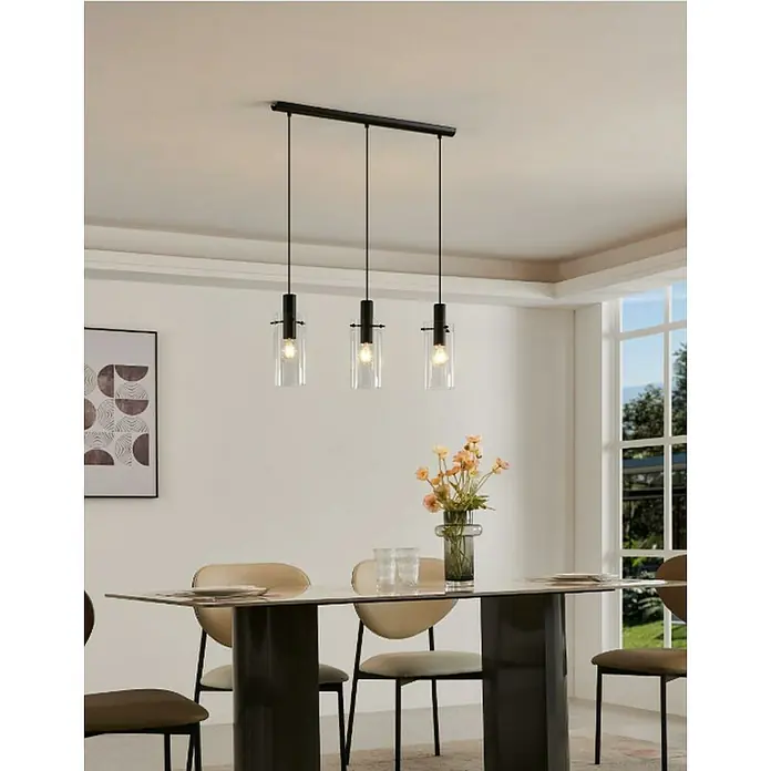 Eglo Lámpara colgante Montefino - Potencia máx. del sistema: 180 W, Número de bombillas: 3 ud. - Elegante lámpara colgante con tres cilindros de vidrio transparente y suspensión negra sobre una mesa de comedor.