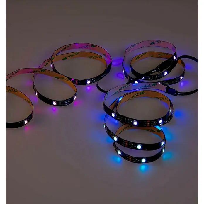Trio Lighting Tira LED inteligente Screen - Largo: 3 m, RGBW, 3,5 W, 230 V - Tiras LED multicolores con adhesivo 3M sobre una superficie clara, proporcionando iluminación ambiental.