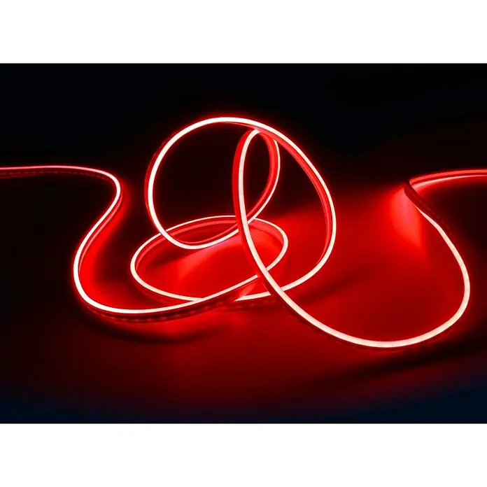 Trio Lighting Tira LED Neon - Largo: 3 m, RGB - Un tubo de neón LED rojo, dispuesto artísticamente sobre una superficie oscura. Es brillante y llama la atención por su luz.