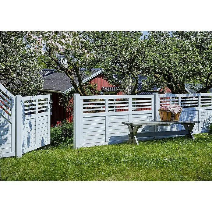 Plus Sichtschutzelement Decora - 180 x 95 cm, Holz, Weiß RAL 9010 - Weißer Gartenzaun und Tor aus Holz mit passender Holzbank in einer grünen Gartenumgebung.