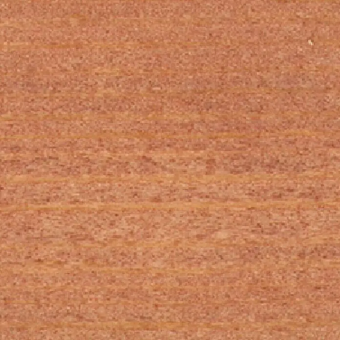 Clou Aqua Holzbeize - Kirschbaum, 250 ml - Nahaufnahme eines Stücks rötlich-braunen Holzes mit einer markanten Maserung. Ideal für den Möbelbau.