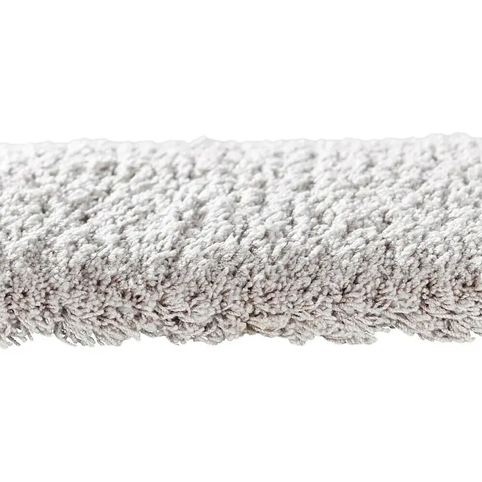 Alfombra de pelo largo Shaggy Super Soft - Ivory, 150 x 80 cm, 100 % poliéster (pelo / felpa) - Primer plano de una superficie de alfombra gris con una textura suave, ideal para espacios habitables y aislamiento acústico.