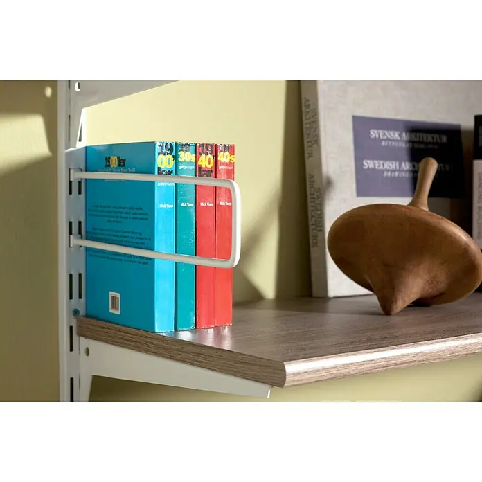 Element System Soporte para libros - 250 x 80 mm, Aluminio blanco, Acero - Una estantería con una selección de libros y una peonza de madera decorativa, que añade un toque de encanto a la composición.