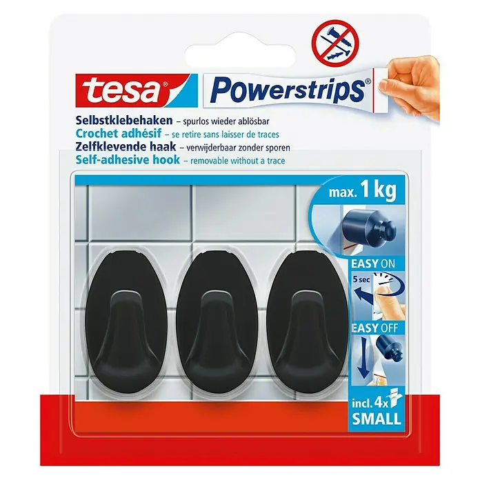 Tesa Powerstrips Selbstklebehaken - Oval, Größe: S, Schwarz, 3 Stk. - Das Bild zeigt eine Packung Tesa Powerstrips Selbstklebehaken. Die Haken sind schwarz und für eine maximale Belastung von 1 kg ausgelegt.