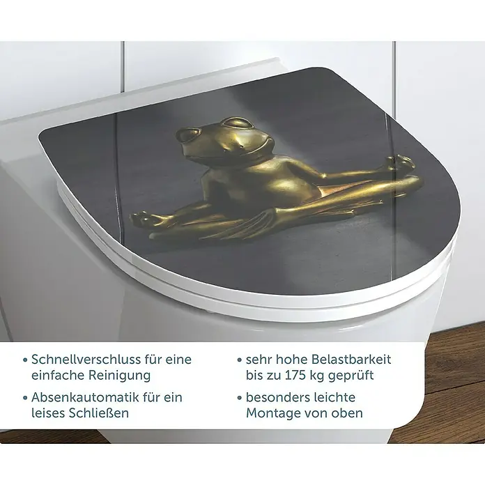 Schütte WC-Sitz Relaxing Frog - Duroplast, Grau/Gold, Mit Absenkautomatik - Nahaufnahme eines WC-Sitzes mit einem goldenen Froschmotiv und Produktinformationen im Vordergrund.