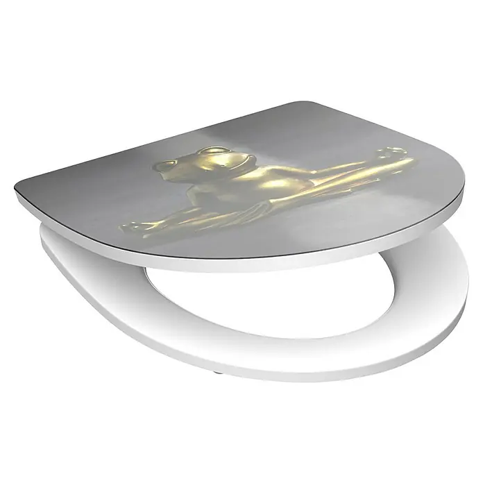 Schütte WC-Sitz Relaxing Frog - Duroplast, Grau/Gold, Mit Absenkautomatik - Ein weißer Toilettensitz mit einem goldenen Froschmotiv auf dem Deckel, der einen Hauch von skurrilem Stil ins Badezimmer bringt.